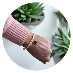 Veterarmband wit met zwart klavertje goud